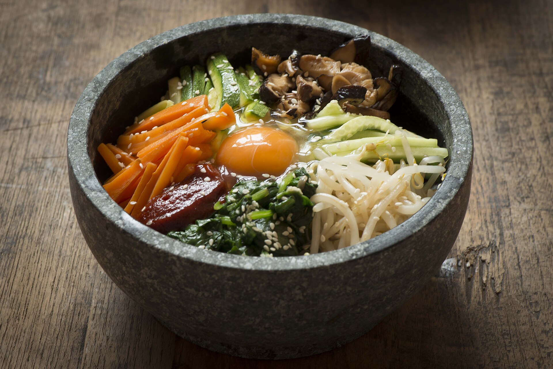 Dolsot bibimbap: mixed rice, vegetables, egg and chilli paste in a hot stone bowl